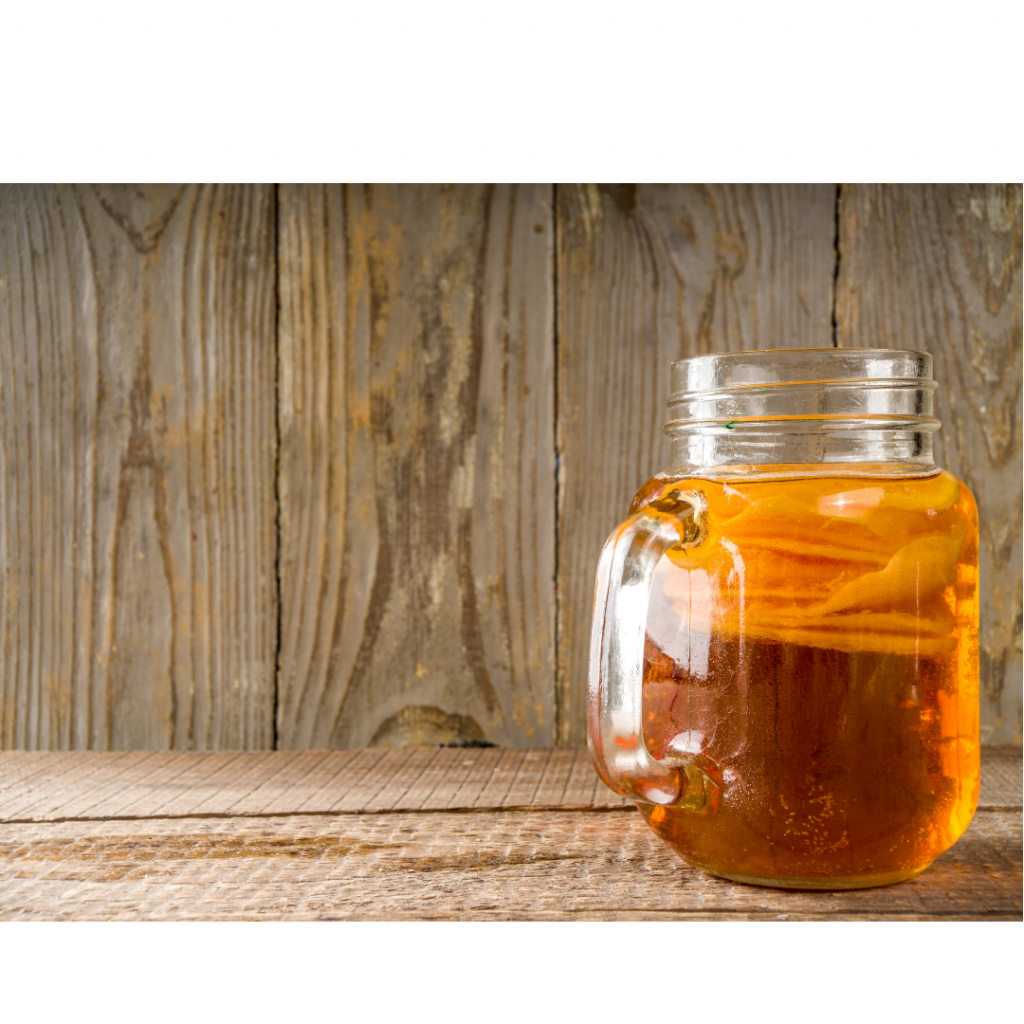 glass jar with historically fermented kombucha drink
