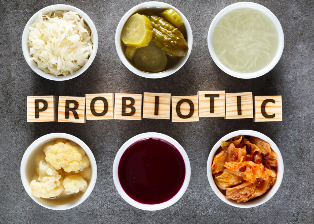 Six jars of beneficial fermented foods with blocks spelling "probiotic" in between them.