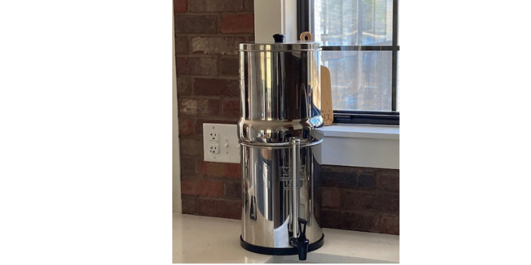 Berkey water filtration system sitting on white counter top.